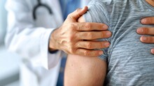 Doctor Examining A Patients Painful Shoulder Using Diagnostics To Identify Issues Like Rotator Cuff Tears Or Impingement