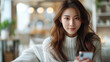 Fashionable Young Woman in Cozy Sweater Using Smartphone, online shopping concept..Fashionable Young Woman in Cozy Sweater Using Smartphone..