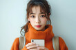 Youthful Beauty in Orange Turtleneck Engaged with Smartphone, Online Shopping