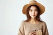 Serene Woman in Beige Hat Using Smartphone with Shopping Bag, Space for Text