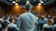 Business Coach Leading Seminar, business coach commands attention from an audience, confidently addressing a crowded seminar in a modern conference room