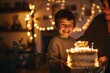 Boy smiling with glee holding a birthday cake in a warmly lit room