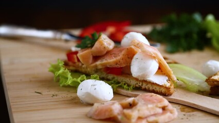 Wall Mural - fried toast with salmon, cream cheese, salad, on a wooden table