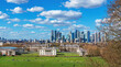 View of the famous Greenwich Park, Thames River and the financial district Canary Wharf on the horizon on a sunny day in South East London, UK