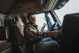 Fototapeta Panele - Happy confident male driver sitting in  his truck, using his tablet