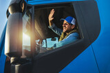 Fototapeta Panele - Young handsome man working in towing service and driving his truck.