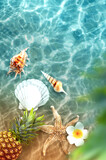 Fototapeta Desenie - Yellow pineapple, seashells and flowers on a blue water background.