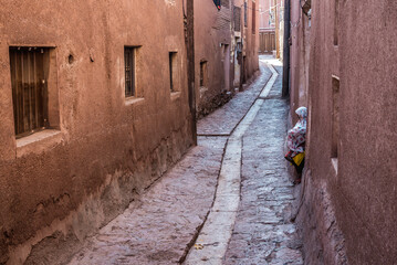 Sticker - Narrow street with drainage canal in Abyaneh historic village in Barzrud Rural District, Iran