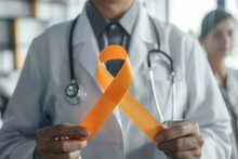 A Doctor Holding An Orange Ribbon In His Hand