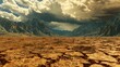 Arid desert landscape with cracked earth and mountains in the distance. This image shows a barren desert landscape with cracked earth and mountains in the distance. The sky is dark and cloudy.