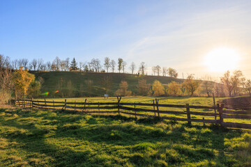 Wall Mural - A large, open field with a fence in the middle