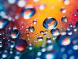 Water droplets on glass against blurred colored backdrop.