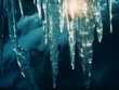 Icicles backdrop features dark blue-green hues in close-up.
