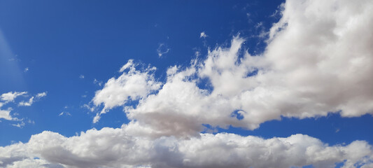 Wall Mural - A blue sky with scattered clouds on a beautiful sunny day