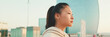 © Andrii Nekrasov - Close up, asian girl in sportswear stands at morning time on modern buildings background, Panorama