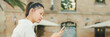 © Andrii Nekrasov - Young woman sitting on bench and using mobile phone, Panorama