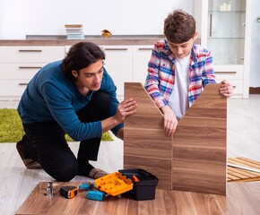 Wall Mural - Young carpenter teaching his son