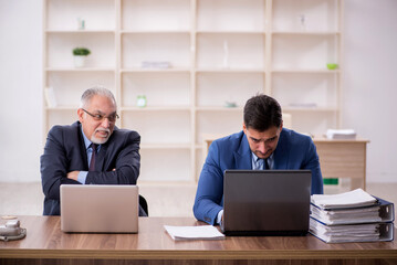 Poster - Two male employees working in the office