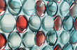 A concept related to pharmaceutical medicine, featuring serial repetition and hues of dark teal, light silver, light indigo, and red.