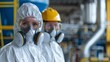 A Two professionals in hazmat suits with protective masks in an industrial setting