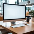 © Patcharaphorn - monitor white screen mockup with blank screen while working at office