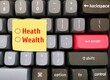 Computer keyboard with text written note WEALTH or HEALTH  - Concept of work life balance - decision making to choose between health happiness or financial success