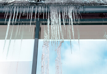 Wall Mural - Icicles hang from a glass building