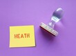 Rubber stamp on purple background with text on note HEALTH -  Health is very important and must not be neglected -  health is greatest wealth and asset