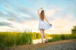 © boomeart - Young woman enjoying sunset standing by the river bank