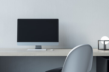 Wall Mural - close up of empty mock up computer screen at modern designer office workplace in interior. concrete 