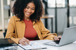 © Nuttapong punna - Confident business expert attractive smiling young woman holding digital tablet  on desk .