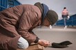 Senior citizen beggar on city overpass begging for some money