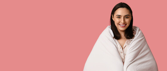 Poster - Pretty young woman with blanket on pink background