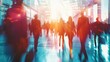 © kittikunfoto - Blurred figures walking in a busy, modern office building with sun flare, representing corporate rush and urban life dynamics.