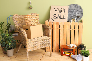 Canvas Print - Many various unwanted things and cardboard with text YARD SALE near green wall in room