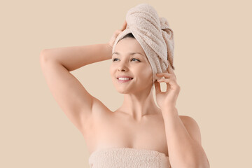 Canvas Print - Young woman in towels after shower on beige background, closeup