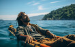 African American man with afro hair is lying and relaxing on the boat with sunshine in the blue sea