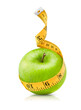 sewing measuring tape wrapped around a green apple on an isolated white background. diet and weight loss concept