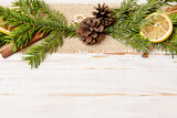 Fototapeta Kwiaty - Traditional Christmas decorations with fir garland and dried oranges.