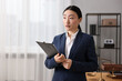 © New Africa - Portrait of notary with clipboard in office. Space for text