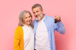 © Prostock-studio - Happy pensioners couple excitedly showing automobile key on pink backdrop