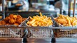 A commercial French fries deep-frying machine, with stainless steel frames and metallic mesh basket shelves filled with golden French fries.
