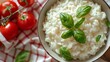 A bowl of rice with basil leaves and tomatoes on a table, AI
