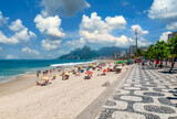 Fototapeta Paryż - Ipanema beach with mosaic of sidewalk and mountain Dois Irmao (Two Brother)  in Rio de Janeiro, Brazil. Ipanema beach is the most famous beach of Rio de Janeiro, Brazil. Cityscape of Rio de Janeiro