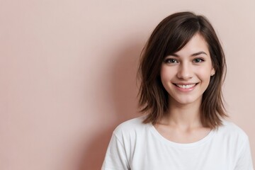 Wall Mural - Happy young transgender woman wearing a white shirt standing against a pink background with copy space.