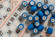 Tabletop old lotto game with cards and blue barrels on table, closeup, top view