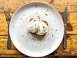 two poached eggs on a white plate from bits eye view