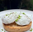 close up of two soft poached eggs with chives