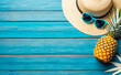 advertising of travel agencies, tour operators. Summer vacation banner. straw hat, sunglasses, palm branches, and pineapple on wooden background. Top view with wide composition and copy space