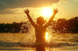 boy bathes in the river , splashes against sunset background